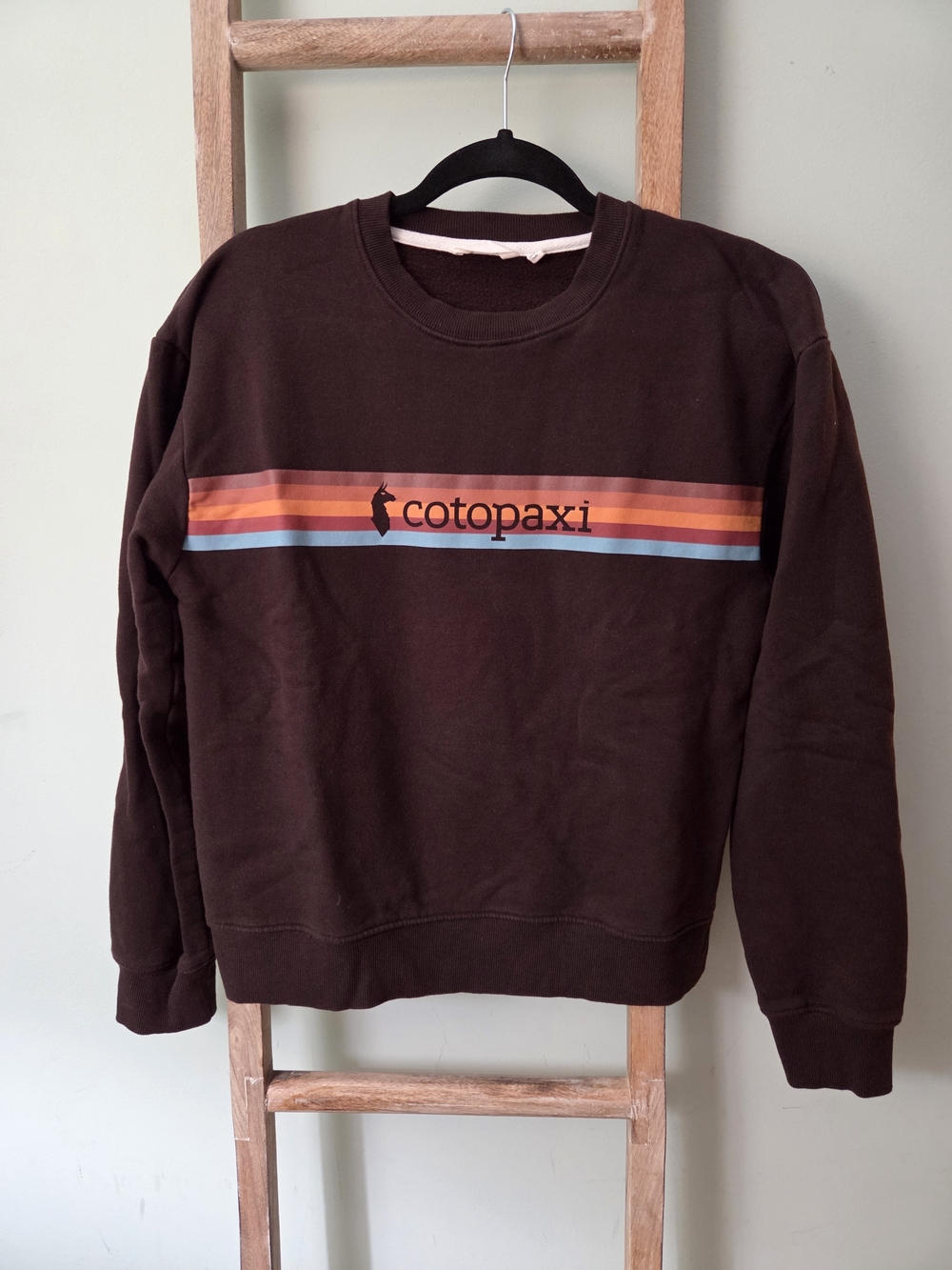 cotopaxi brown crewneck sweater with orange and blue stripe